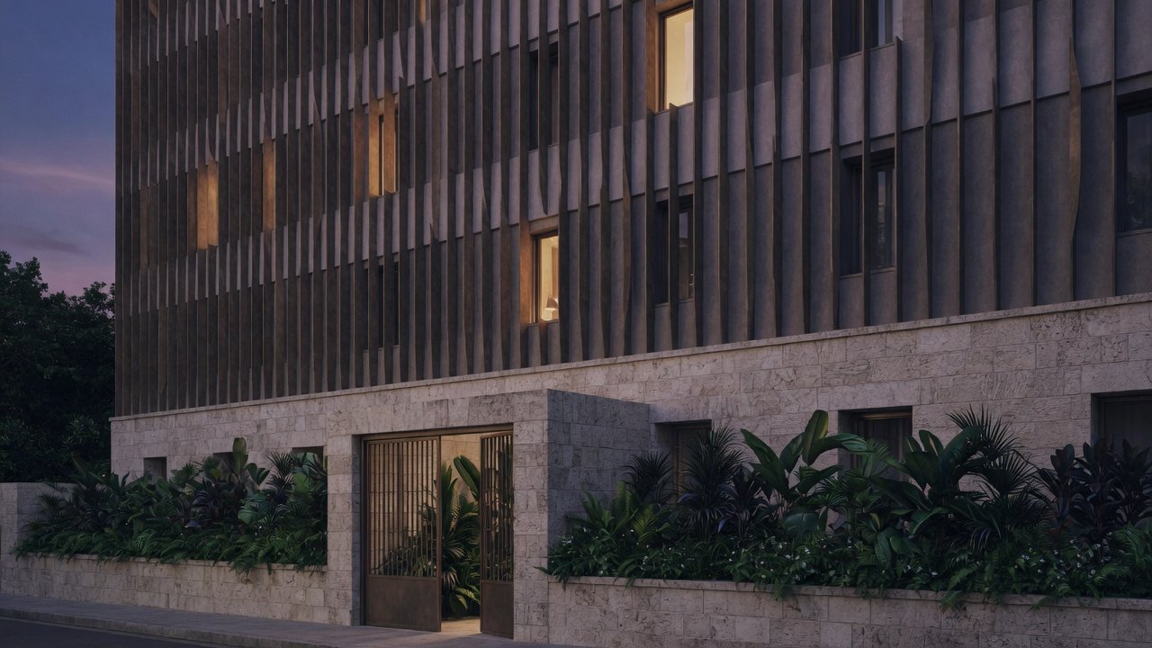 A stone-based residence with a screen of tall bronze fins and a planted wall at dusk.